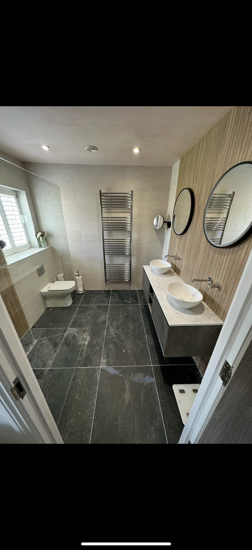 Spacious ensuite with slate floor, oak feature wall and twin vessel basins — Basingstoke
