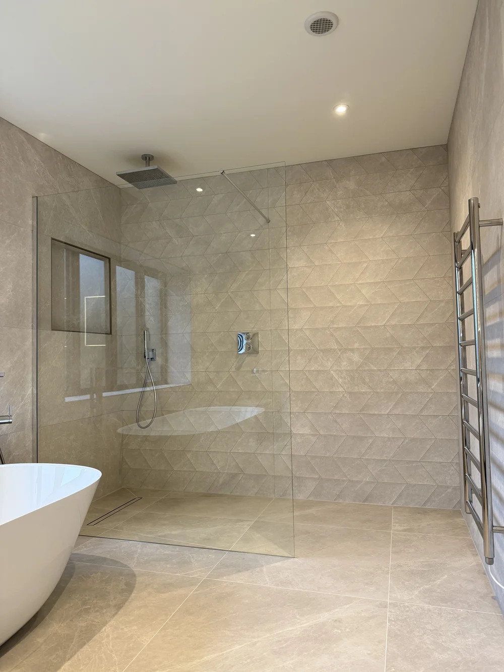 Luxury wet room with freestanding bath, rainfall shower and chevron tiling — Basingstoke