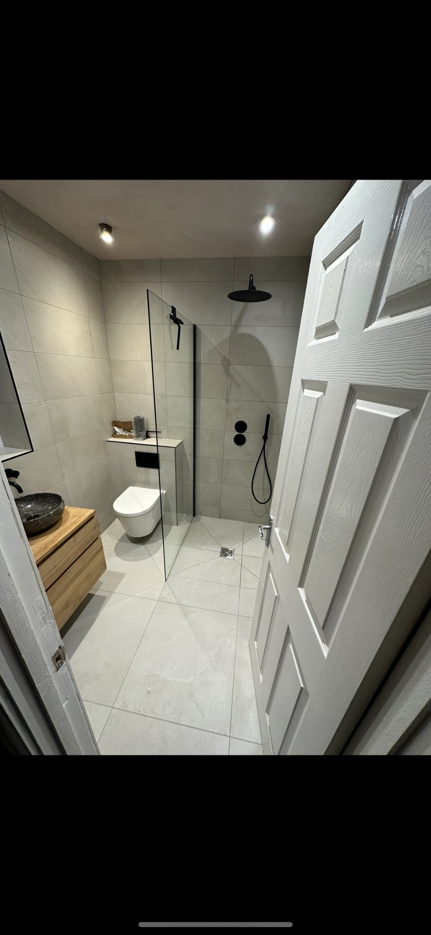 Modern wet room with oak vanity, stone vessel and matte black shower fittings — bathroom installation Basingstoke