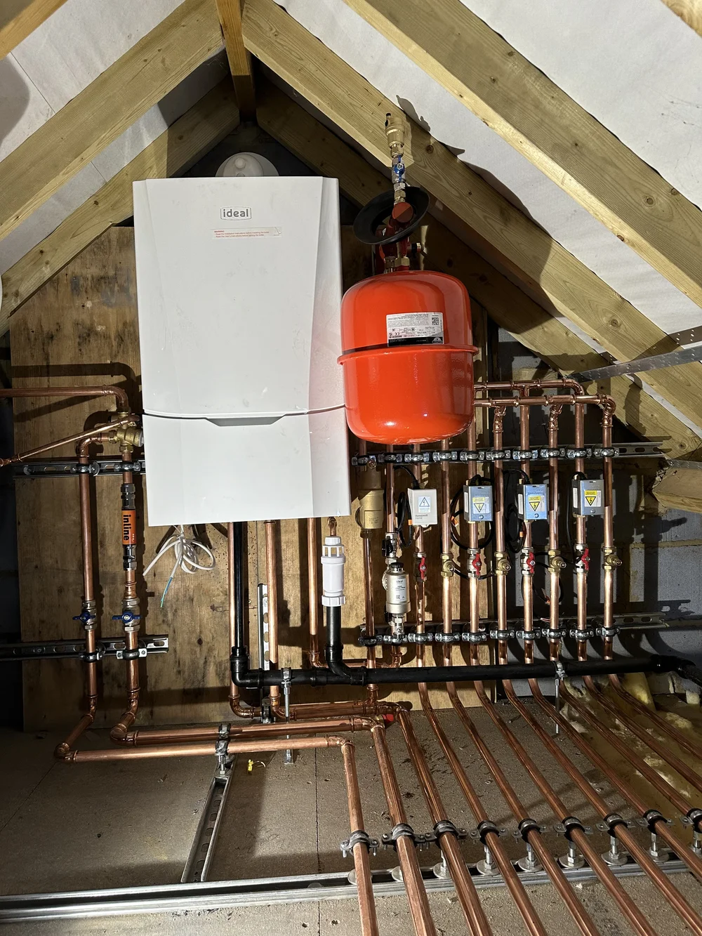 Ideal boiler with copper manifold, zone valves and magnetic filter in loft — plumber Basingstoke
