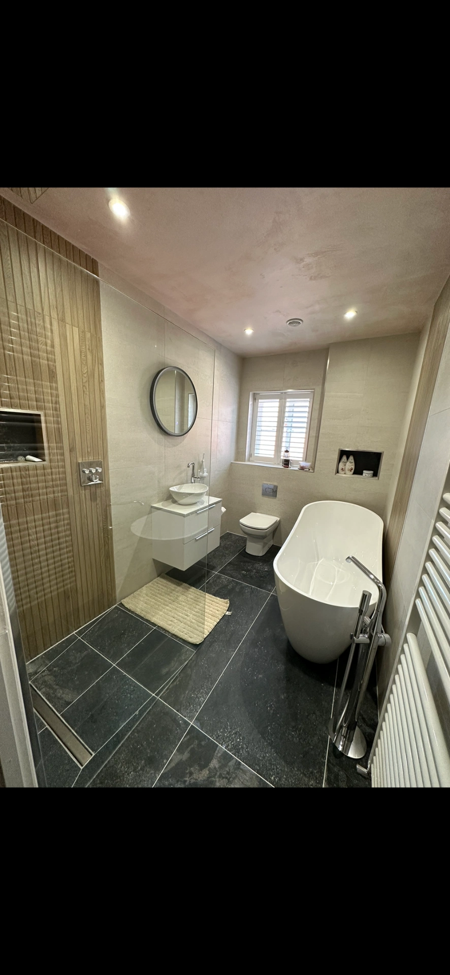Master bathroom with freestanding tub, slate floor and oak-panelled walk-in shower — bathroom installation Basingstoke