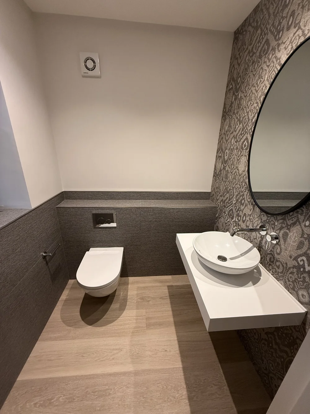 Bespoke cloakroom with patterned wallpaper, oak floor and floating vessel basin — Basingstoke