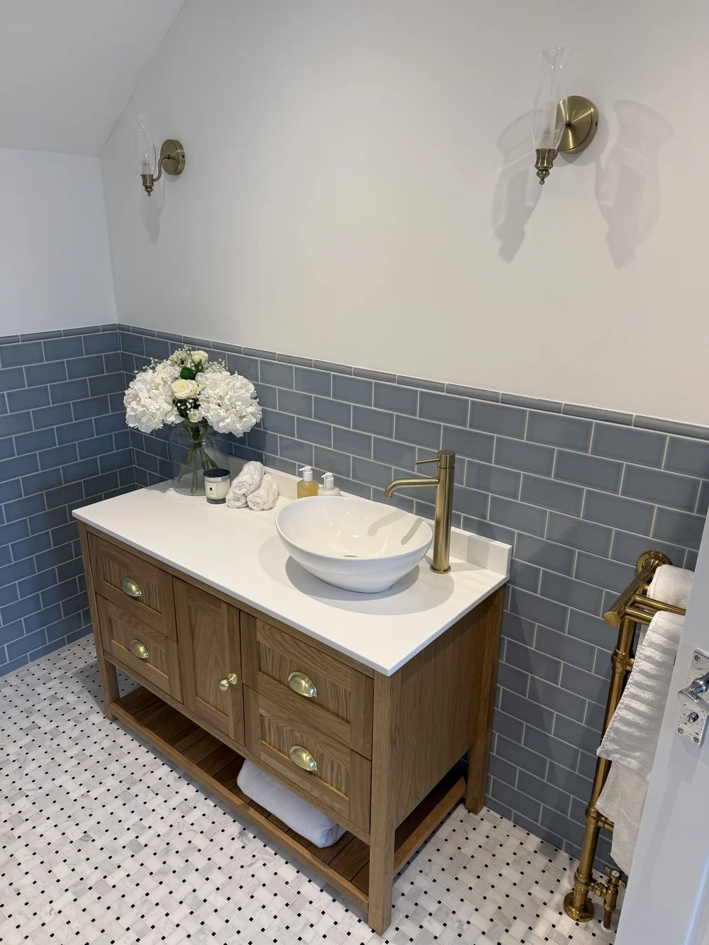 Oak vanity with vessel basin, brass tap and blue metro tiles — bathroom design Basingstoke