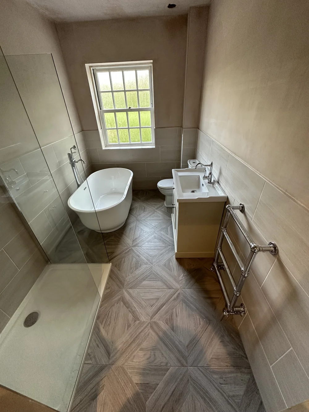 Traditional bathroom with freestanding slipper bath, cream shaker vanity and parquet floor — bathroom renovation Basingstoke