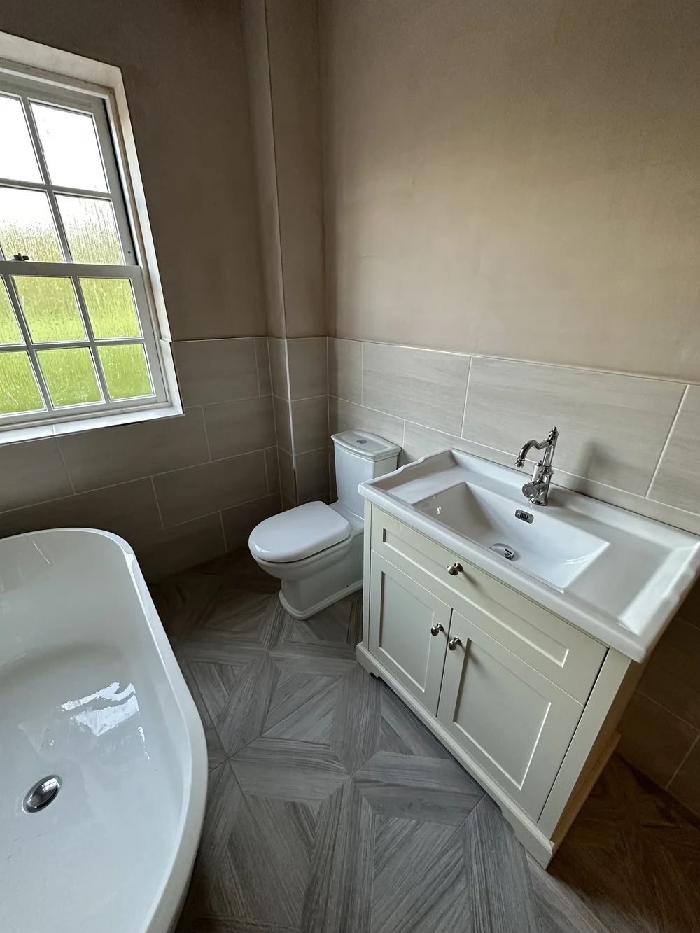 Traditional bathroom with cream shaker vanity, chrome tap and parquet floor — bathroom renovation Basingstoke